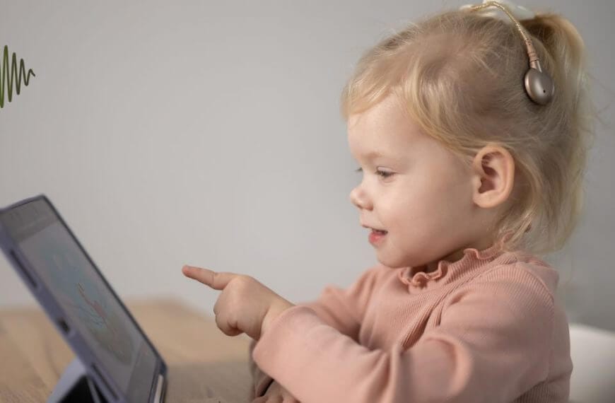 Picture a young child in a vibrant pink top, completely engrossed in their learning tablet. With the power of a cochlear implant we are opening worlds of opportunity for hard of hearing youth. Together, let's amplify their potential and transform challenges into triumphs.